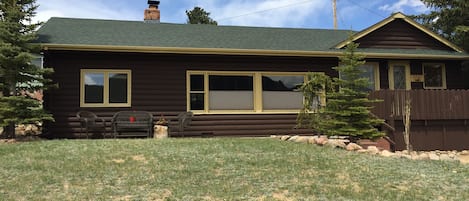 Front of cabin with yard adjacent to RMNP land, gorgeous mountain views, river.