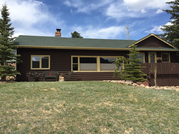 Front of cabin with yard adjacent to RMNP land, gorgeous mountain views, river.