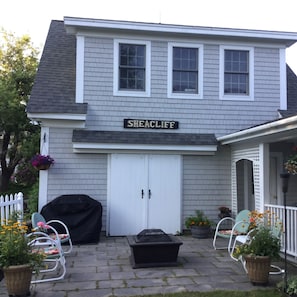 View of 2nd story apartment with the patio, fire pit & gas grill.