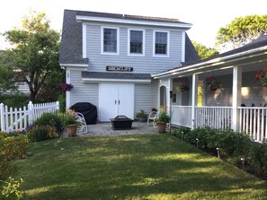 View of upstairs apartment, the patio with fire pit, gas grill & gardens. with 