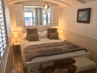 Idyllic “railway carriage” beach house in the historic Sussex village of Pagham.