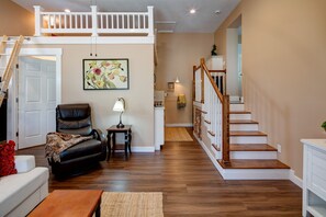 Loft and kitchen with stairs to bedroom.