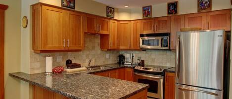 Well-equipped kitchen with granite countertops
