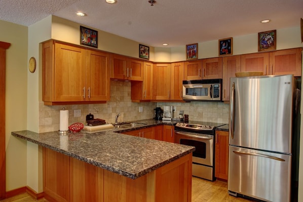 Well-equipped kitchen with granite countertops