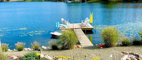 New waterfront pea gravel beach area with lounge area, floating dock and firepit