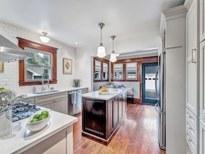 Looking from dining room into kitchen and breakfast nook