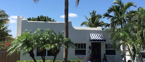 Street view. Nicely manicured front lawn.  Seasonal coconuts!