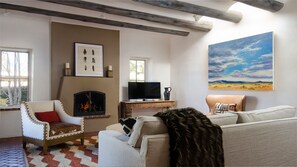 Main living area with wood burning Kiva and flat screen tv.