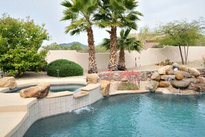 Spa with overflow into the pool.  Mature palm trees.
