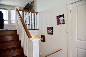 Artwork lining the staircase to get to the upper and lower floors.