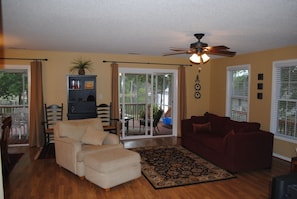 Large open family room and kitchen with hardwood flooring