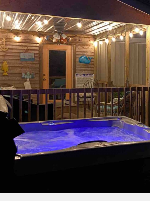 Hot tub by covered deck and gameroom