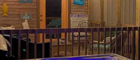 Hot tub by covered deck and gameroom