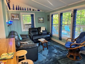 Living room has TV and AC unit.
