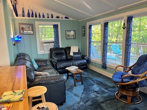 Living room has TV and AC unit.