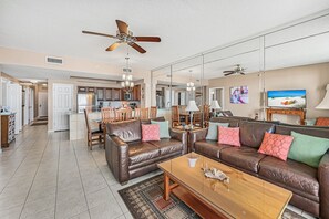 Living area, dining area, kitchen and hallway.