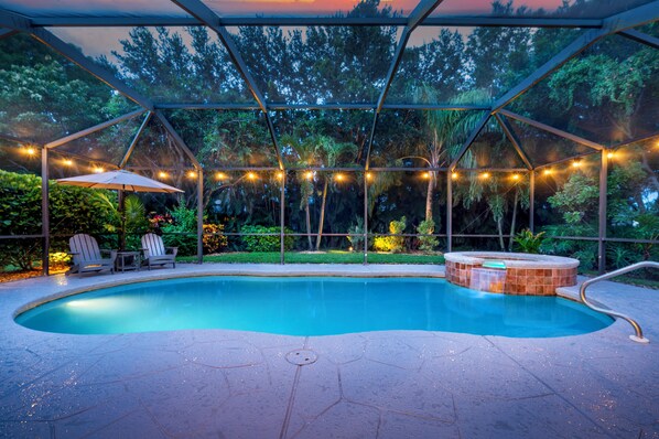 Spacious screened-in pool and spa surrounded by nature—your private outdoor escape