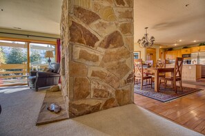 Living room, dining room, kitchen all with window views of the beauty outside