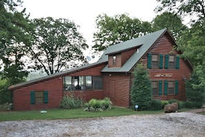 View of front of house.  You can see the lake through the screened-in  breezeway