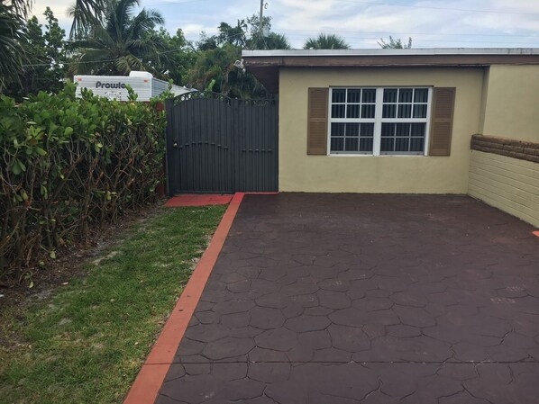 Entrance's front gate and guests parking space