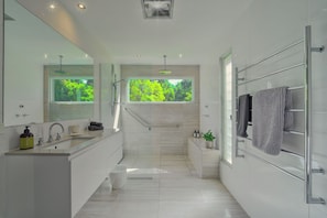 Serene ensuite bathroom with nature views.