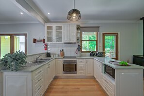 Modern kitchen with extensive cookware and appliances.