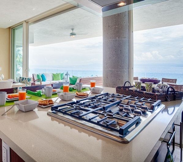 Kitchen next to large ocean front balcony