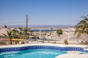 Pool with Lakeview and cement table with seating inside pool.