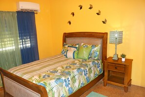 Snuggle up in the cozy queen tropical bedroom with air conditioning.
