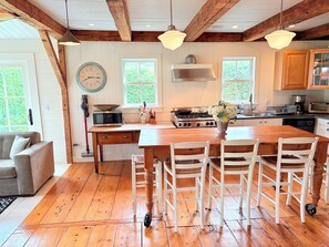 The kitchen is set up for socializing and features a Wolf range