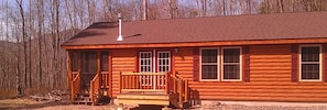 Cottage with mountain views in background.