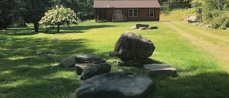 Woodstock Cottage Rental with large lawn and cottage background.