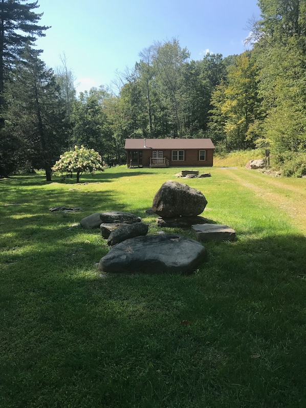 Woodstock Cottage Rental with large lawn and cottage background.