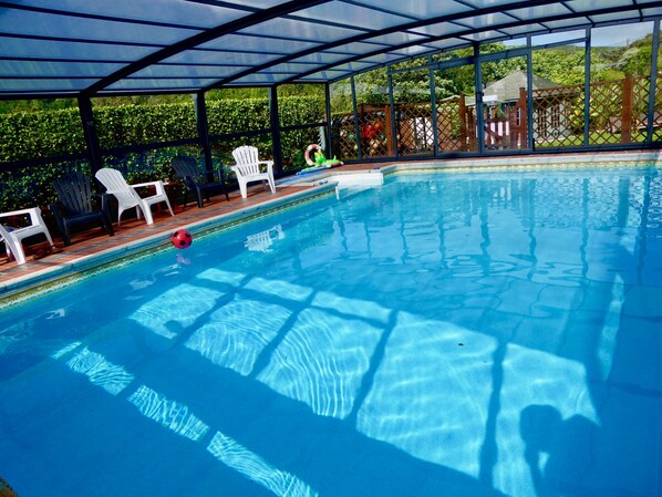 Our covid safe heated pool  has a telescopic enclosure, enjoy a swim and relax