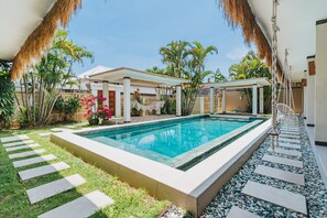 10 meters long pool with bar stools and children friendly garden