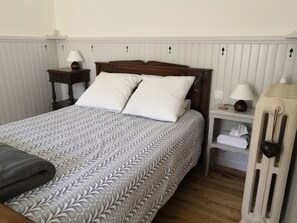 Detail of main bed.  Handcrafted wooden paneling and local oiled chestnut floor 