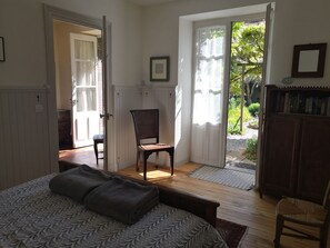 Main bedroom - secure shuttered windows on to the garden 