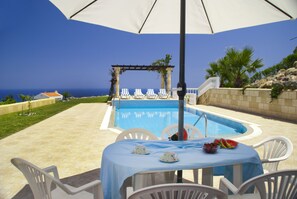 Bougainvillea blooms and island breezes — welcome to Villa Avouri.


