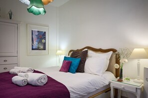 Double bed with luxury linen and towels