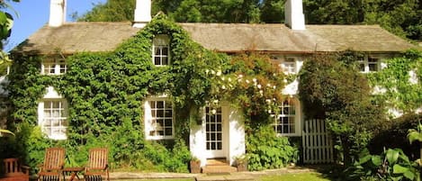 Tom's Cottage. The cottage's front door and the enclosed garden