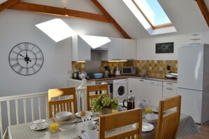 The  kitchen-dining area - the cook doesn't miss out on any of the action!