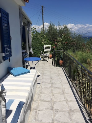 balcony facing the sea, with sunbed and rocking chair