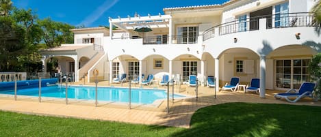 Pool area with fenced in heated pool