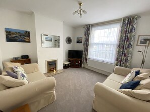 Spacious living room with 2 comfy sofas, fire and flat screen TV