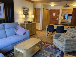 Sitting area looking to kitchen and front door