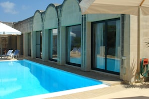 Shaded pool area with unobstructed sea and country views.