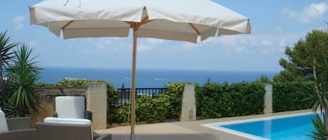 Shaded pool area with unobstructed sea and country views.