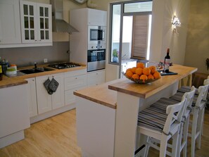 kitchen with breakfast bar and laundry