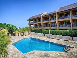 Beautiful pool with sundeck that has an ocean view.  BBQ grills here.