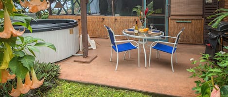 Tropical Hideaway, showing patio entrance with hot tub, outdoor dining, gas BBQ